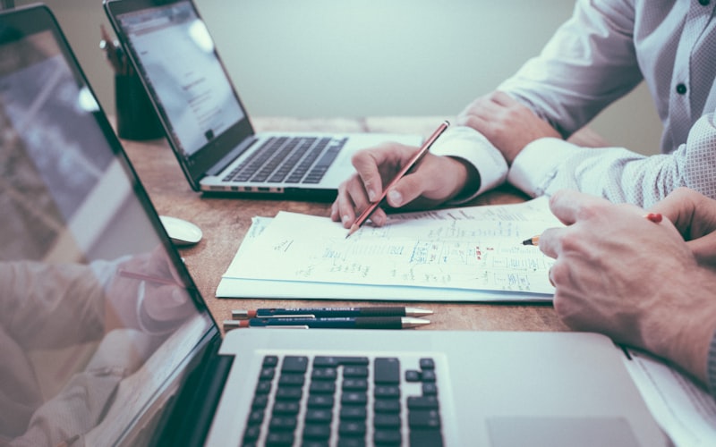 Two people reviewing documents together across a table