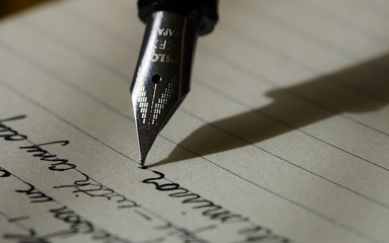 A fountain pen resting on a handwritten page