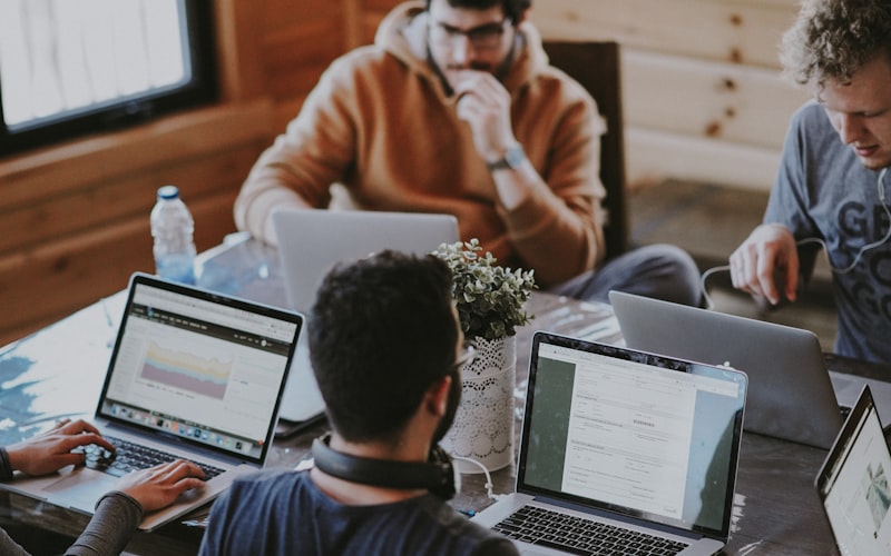 Two founders working side by side at laptops in a bright office